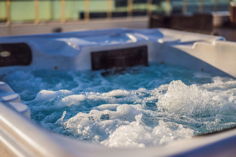 Hot tub hydromassage pool with bubbles forming on top of clean water