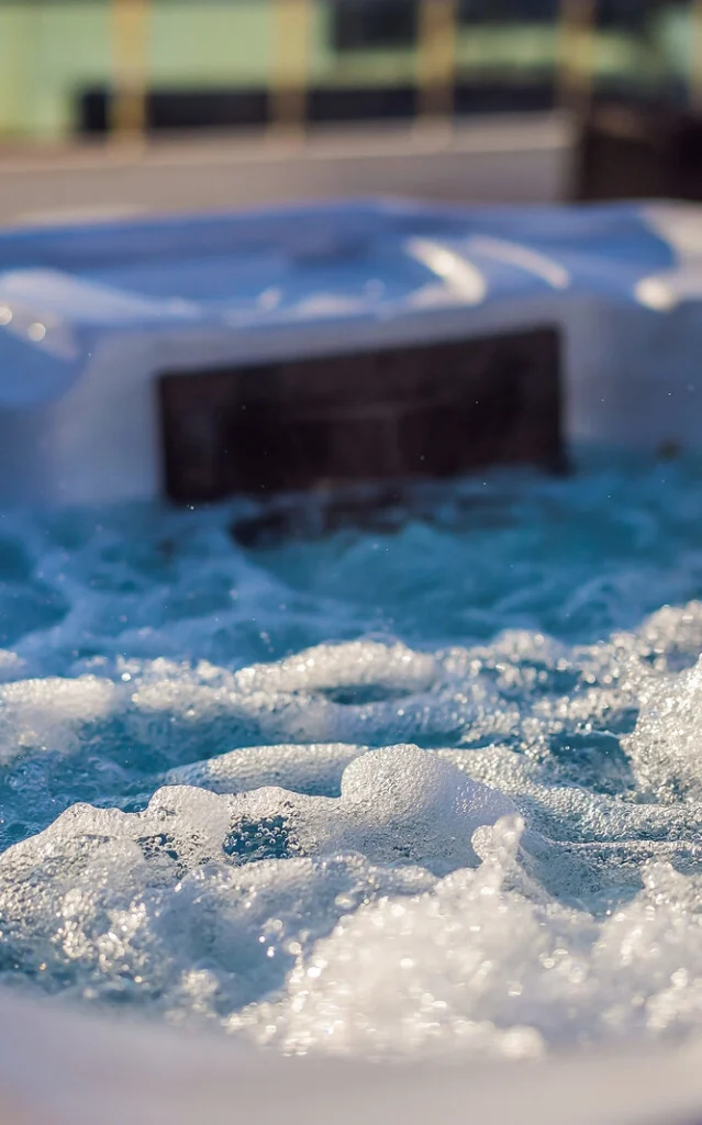 Hot tub hydromassage pool with bubbles forming on top of clean water