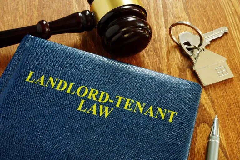A picture of a blue law binding, titled Landlord-Tenant Law on a judges desk.